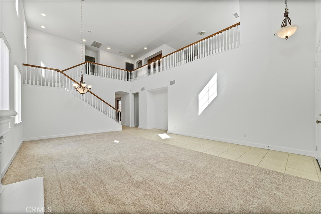 6360 Day Lily Court Rancho Cucamonga, CA 91737 - Photo 7 of 56 a view of an empty room with stairs and a window