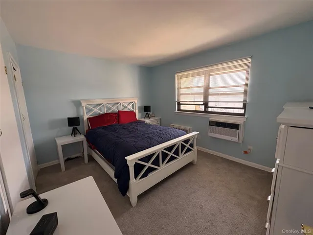 a bed sitting in a room next to a window