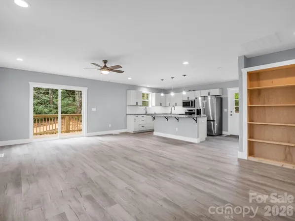 a view of a kitchen with a sink a refrigerator and window
