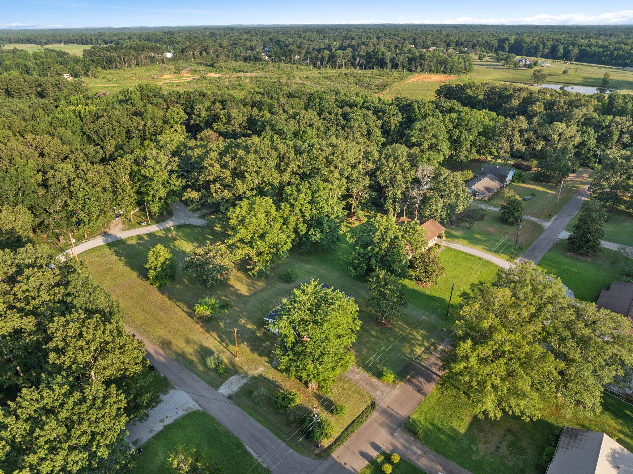 17 County Road 233 Corinth, MS 38834 - Photo 37 of 40 Aerial view of property and surrounding area featuring a heavily wooded area