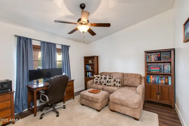 a view of a livingroom with workspace and a window