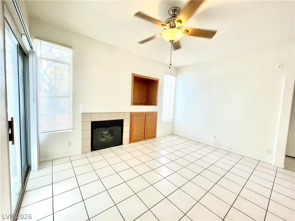 2201 Ramsgate Drive, Unit 915 Henderson, NV 89074 - Photo 18 of 36 A cozy living space features tiled flooring and a classic fireplace with built-in storage.