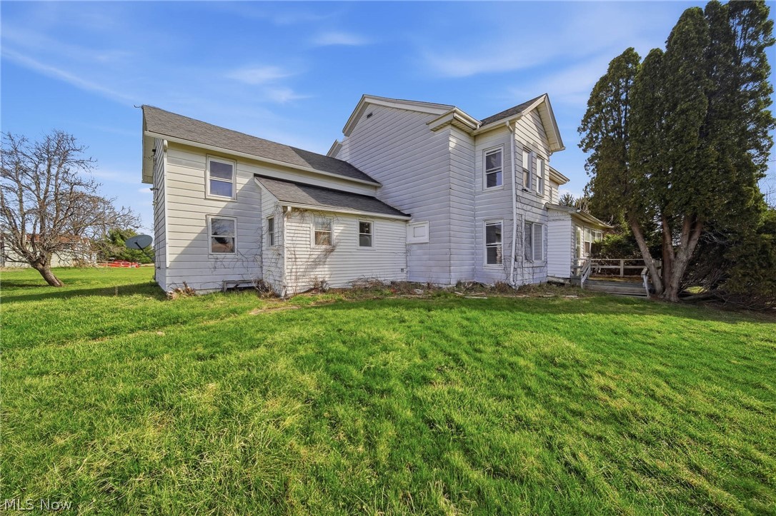 4677 Rock Spring Road Ravenna, OH 44266 - Photo 25 of 35 Rear view of property featuring a lawn and roof with shingles