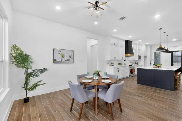 a living room with furniture and kitchen view