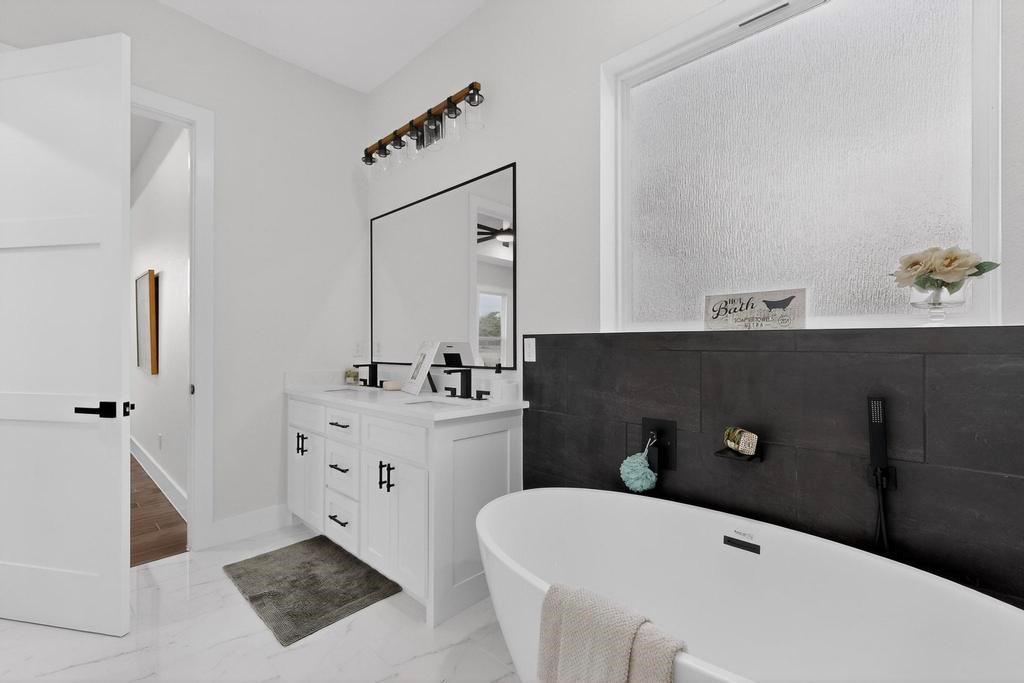9100 County Road 669 Blue Ridge, TX 75424 - Photo 19 of 40 a bathroom with a tub sink and mirror