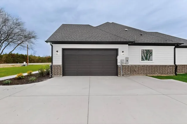 an aerial view of house with yard and ocean