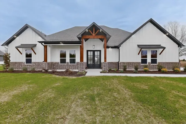 a front view of house with yard and green space