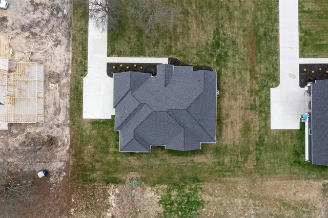 a view of a house with a yard and sitting area