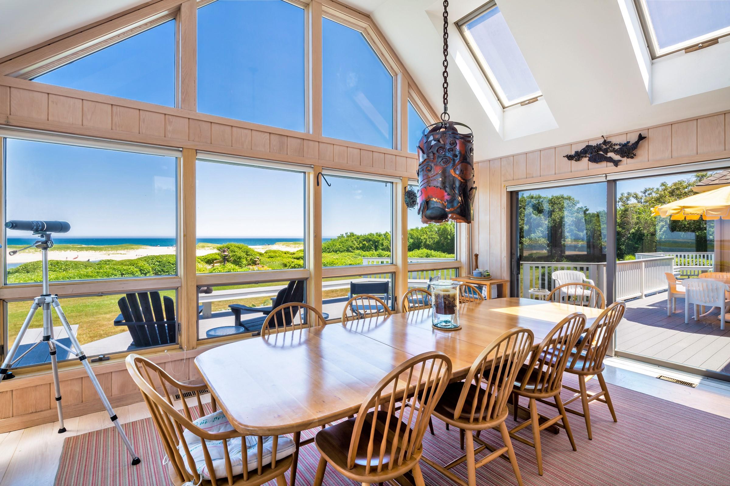 2-7 Skunk Bluff Orleans, MA 02653 - Photo 17 of 80 a dining room with furniture water view and a floor to ceiling window
