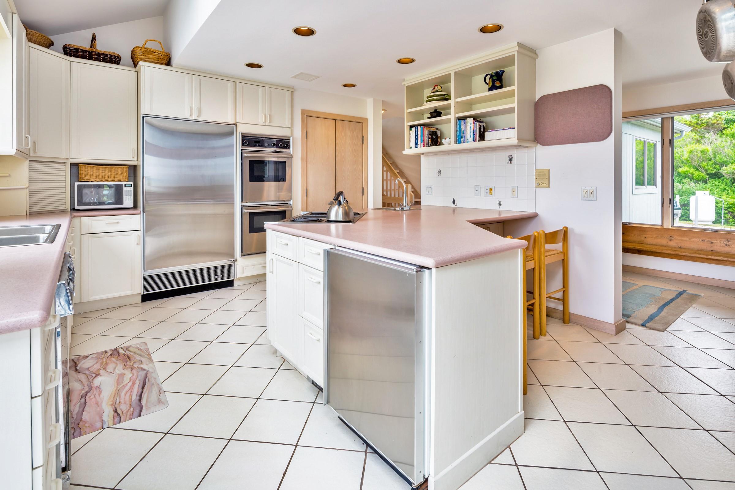 2-7 Skunk Bluff Orleans, MA 02653 - Photo 25 of 80 a kitchen with stainless steel appliances a refrigerator and a stove top oven