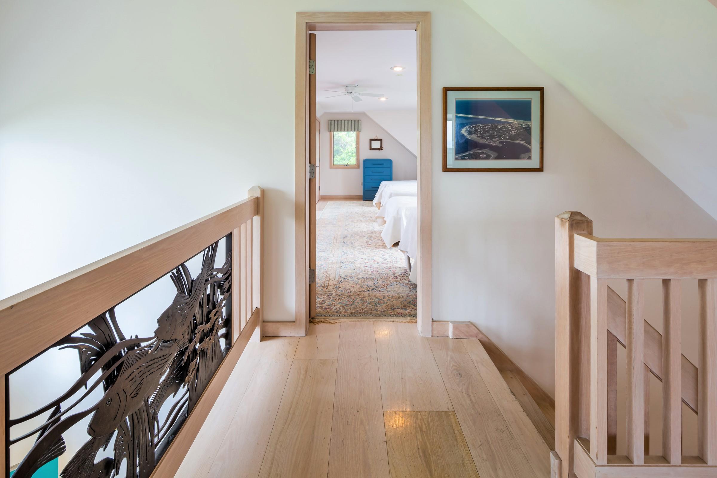 2-7 Skunk Bluff Orleans, MA 02653 - Photo 35 of 80 a view of a hallway with wooden floor and stairs