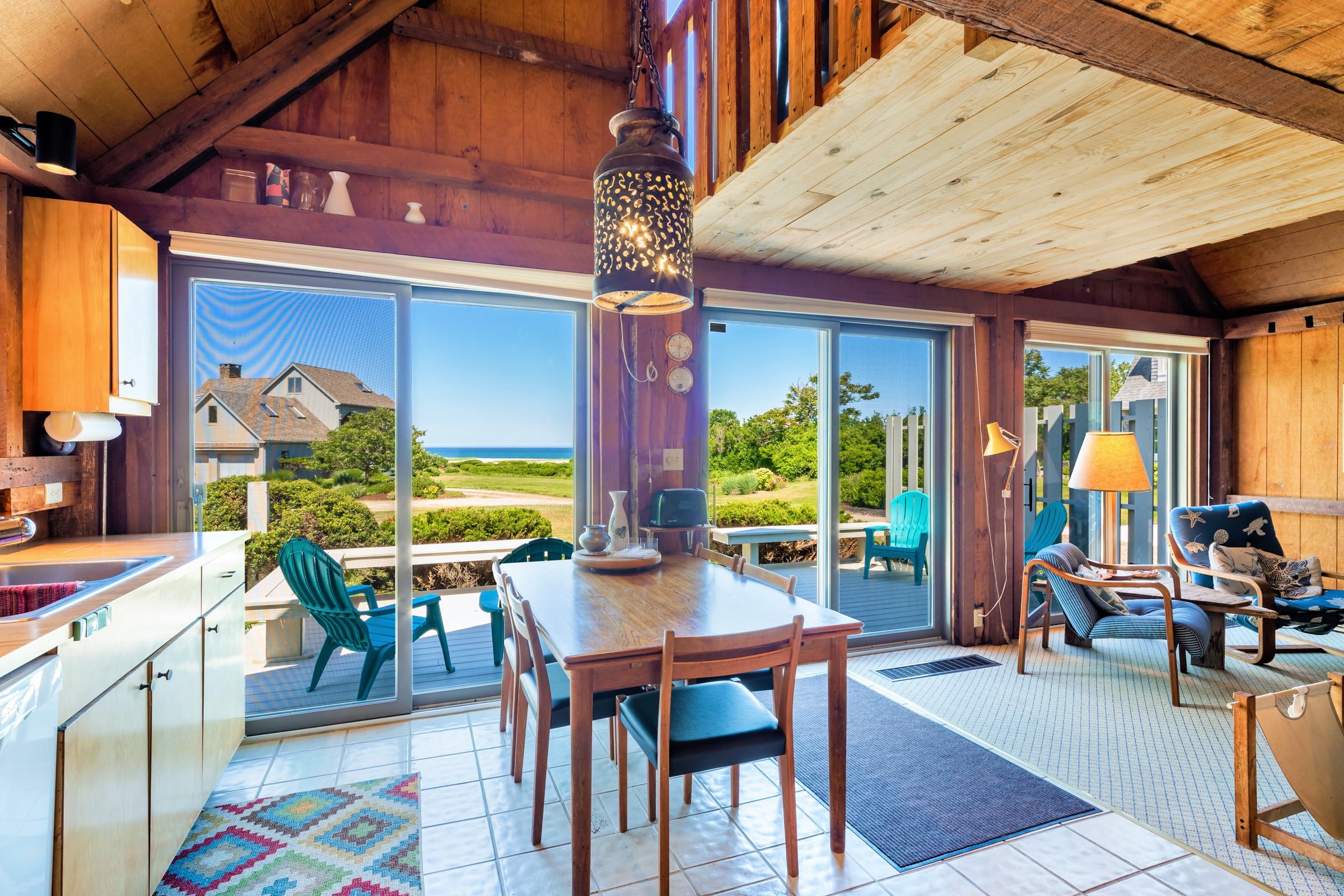 2-7 Skunk Bluff Orleans, MA 02653 - Photo 57 of 80 a dining room with wooden floor table and chairs