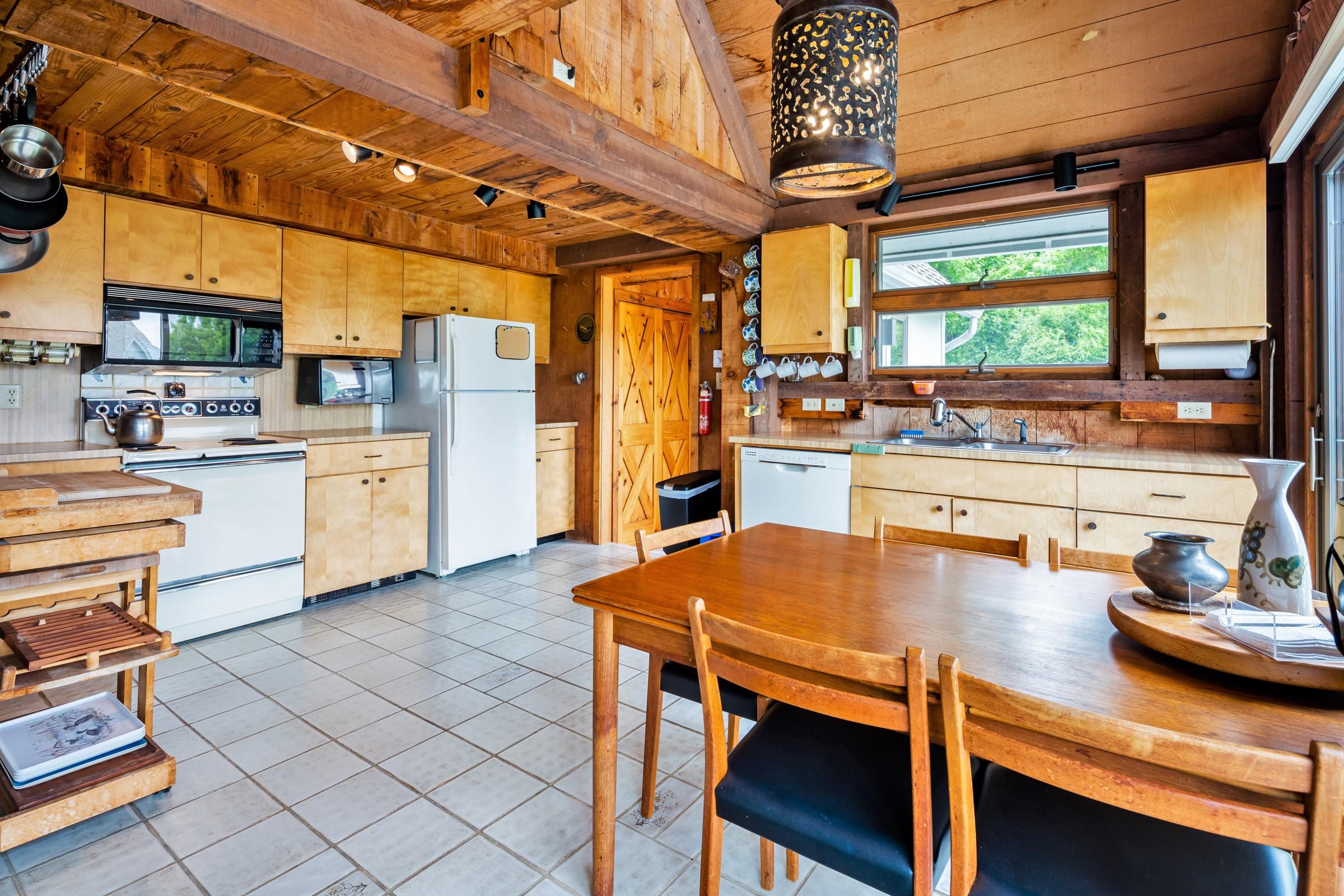 2-7 Skunk Bluff Orleans, MA 02653 - Photo 59 of 80 a kitchen with a table chairs and a stove