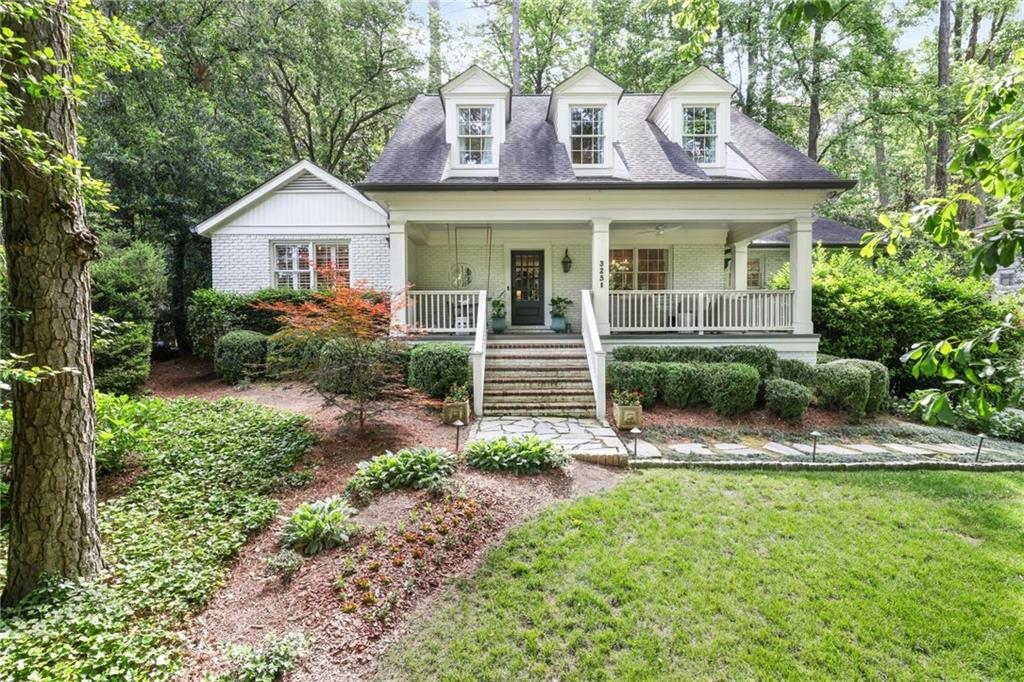 a front view of a house with a yard and outdoor seating