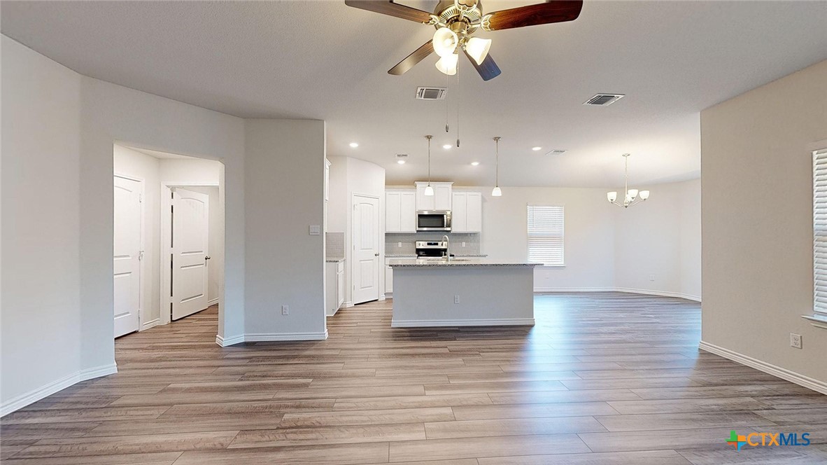 2136 Buckner Street Nolanville, TX 76559 - Photo 15 of 33 a view of kitchen with kitchen island refrigerator stove and wooden floor