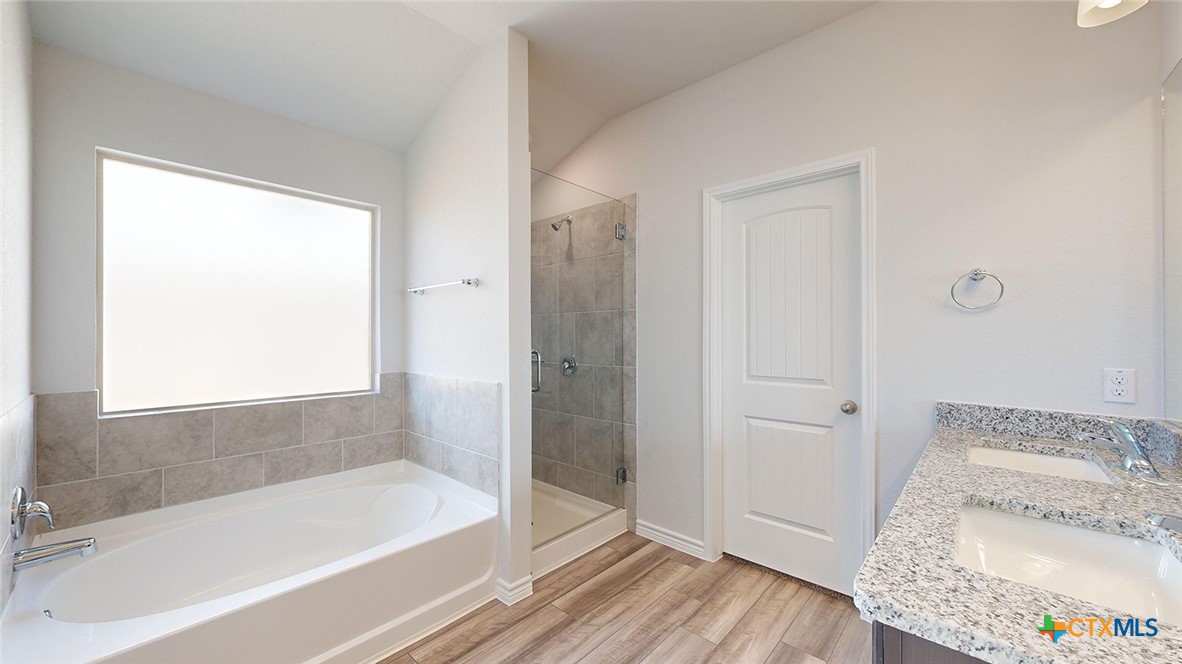 2136 Buckner Street Nolanville, TX 76559 - Photo 23 of 33 a bathroom with a granite countertop bathtub shower and a sink