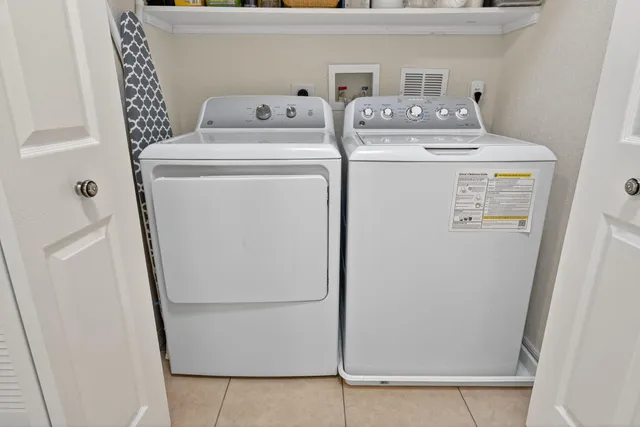 a view of a hallway with workspace and bathroom view
