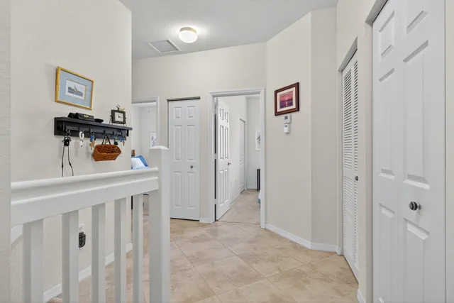 a view of a hallway to a livingroom with furniture