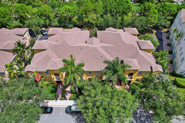 an aerial view of a houses with a yard