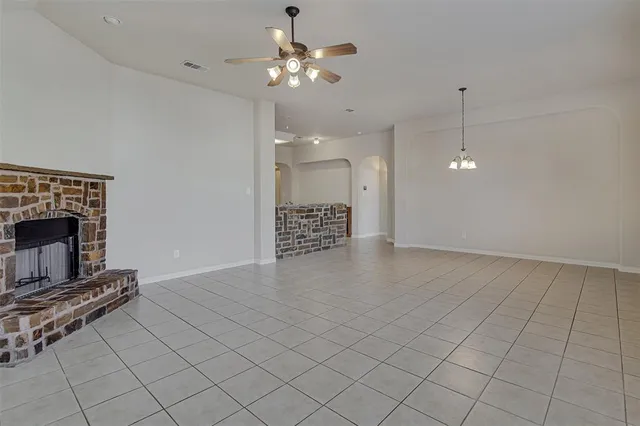 a view of a dining room with furniture a fireplace and a chandelier