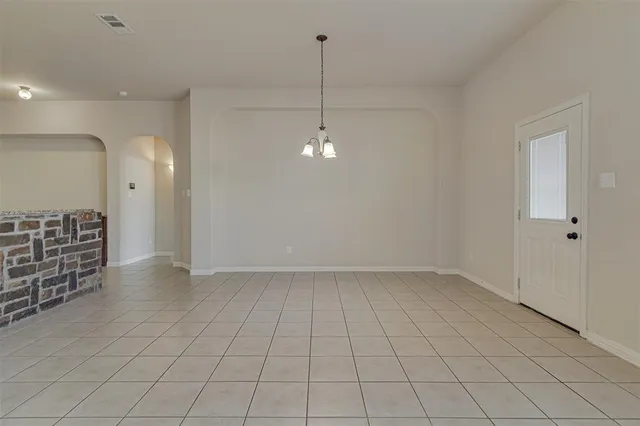 a view of a livingroom with furniture chandelier fan and windows