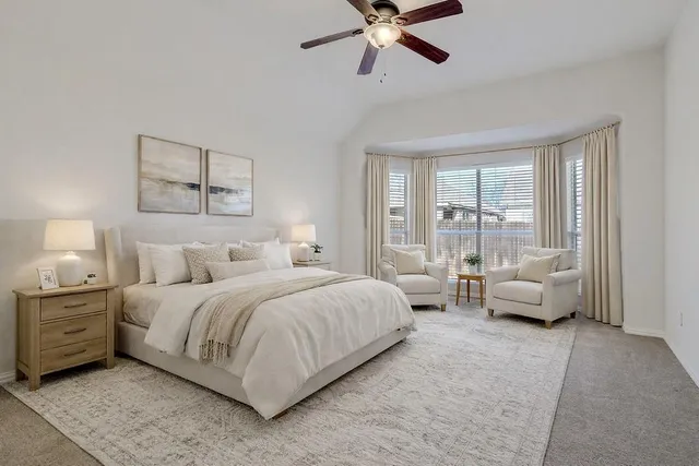 an empty room with a ceiling fan and a window