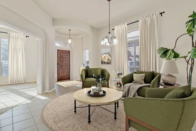 a living room with furniture and a chandelier