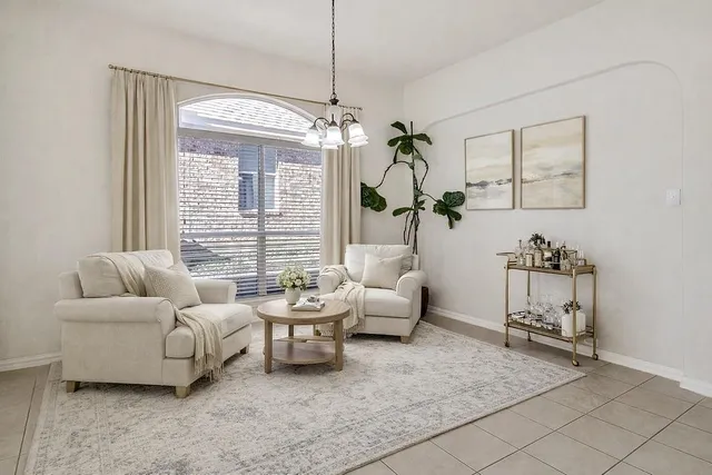 a living room with furniture and a chandelier