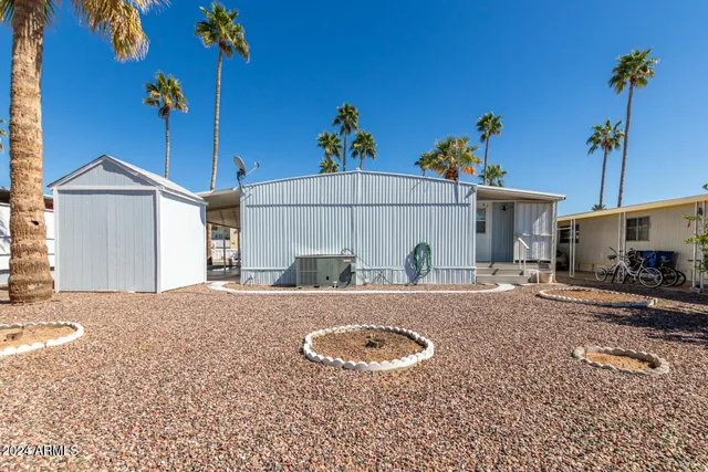 a view of a house with a backyard and sitting area