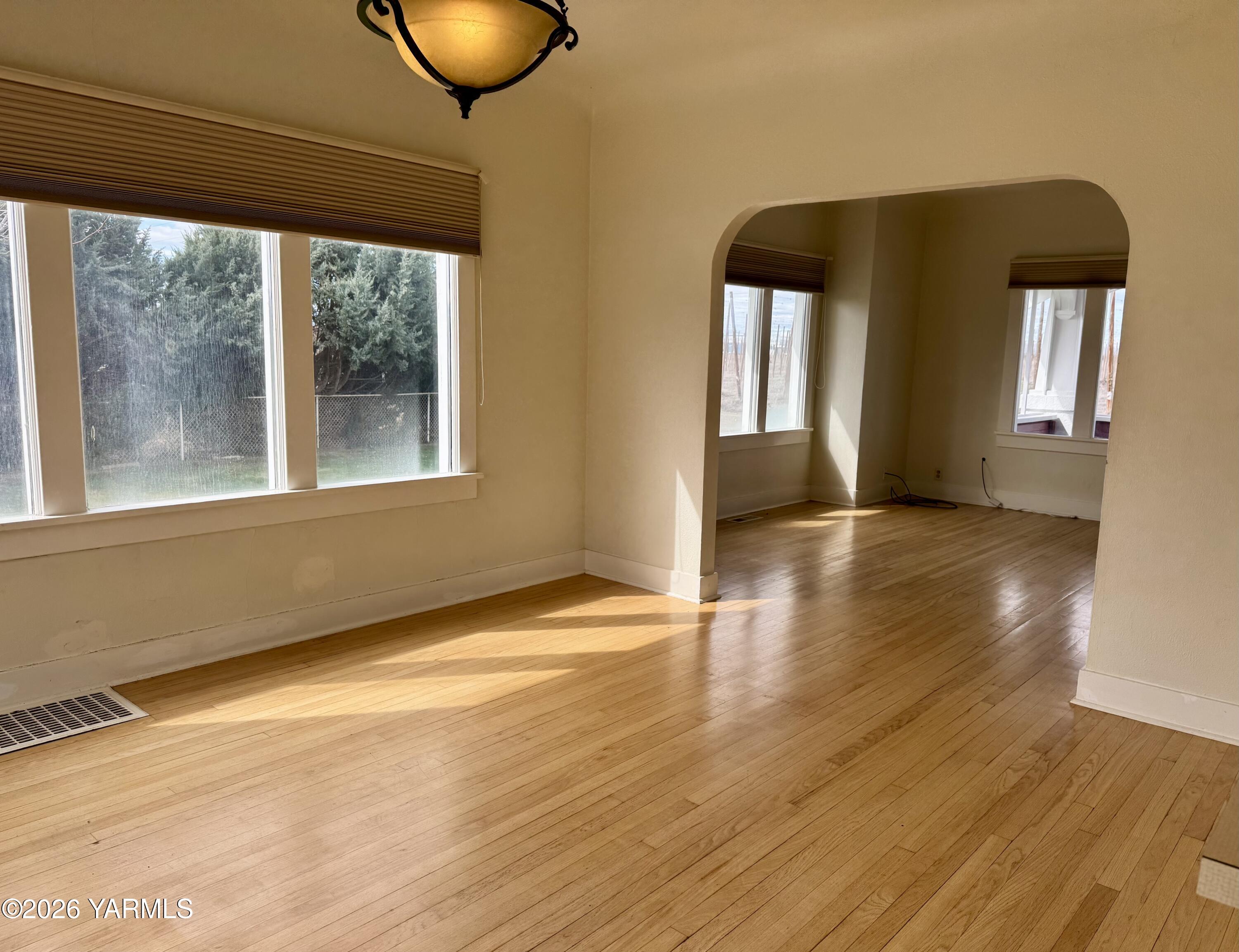 7801 Campbell Road, Unit 1 Toppenish, WA 98948 - Photo 7 of 46 a view of empty room with wooden floor and fan