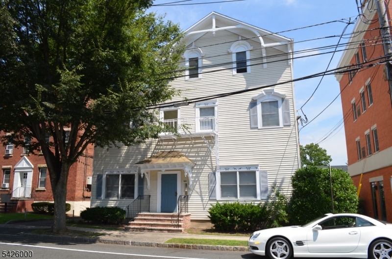 50 Cook Avenue, Unit 1A Madison, NJ 07940 - Photo 1 of 13 a front view of a house with a parking lot