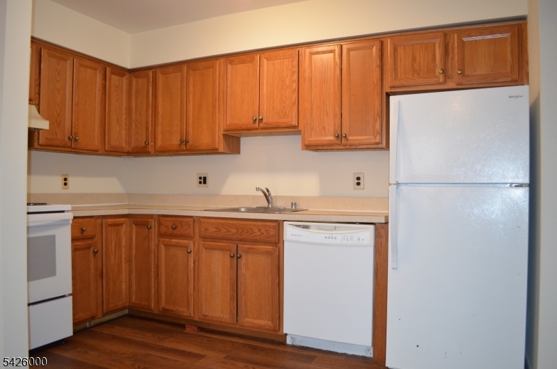 50 Cook Avenue, Unit 1A Madison, NJ 07940 - Photo 4 of 13 a kitchen with a sink a refrigerator and cabinets