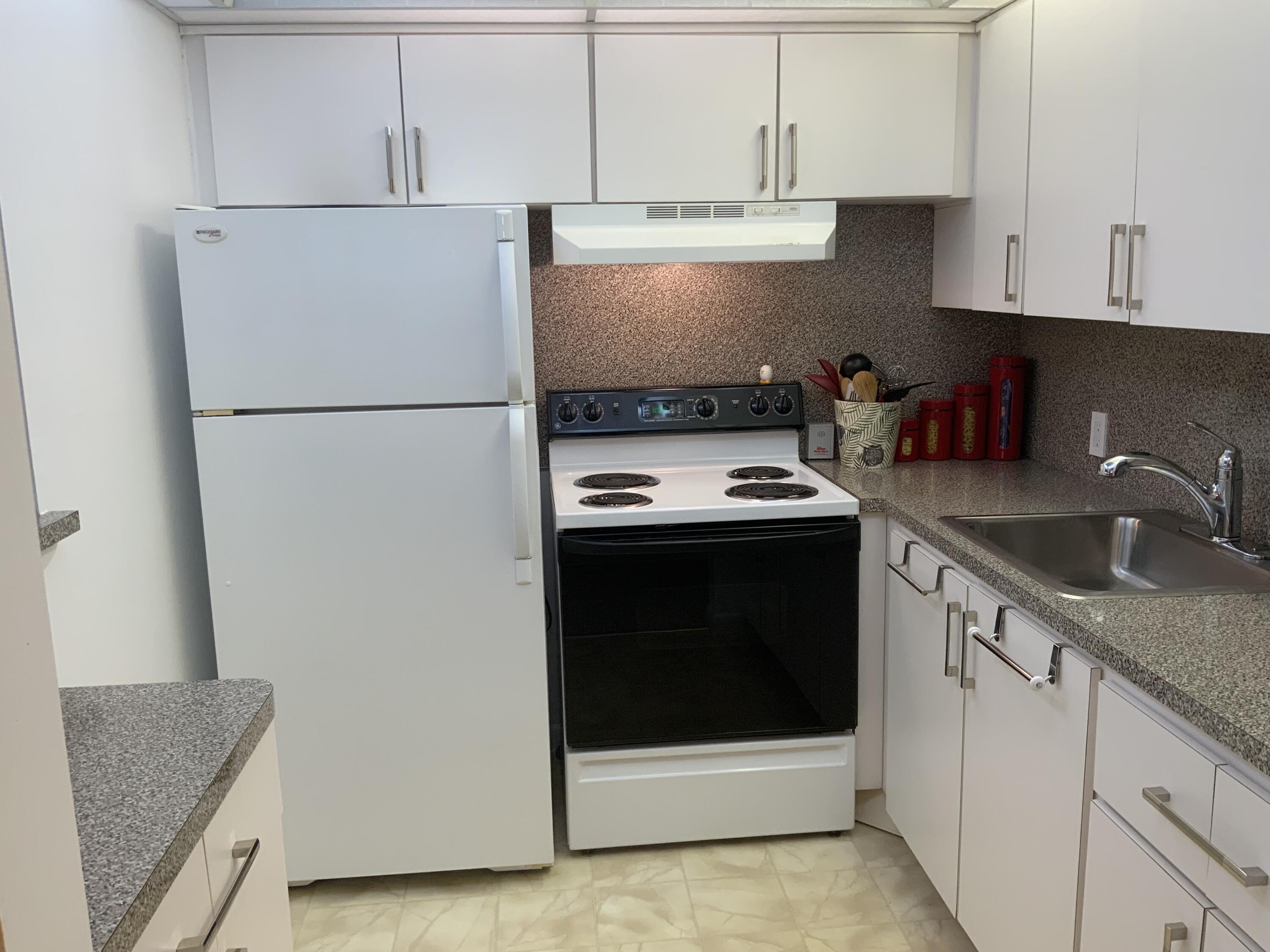353 Dorset I Boca Raton, FL 33434 - Photo 15 of 30 a kitchen with stainless steel appliances granite countertop a refrigerator stove a sink and dishwasher