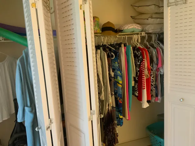 a view of walk in closet with clothes