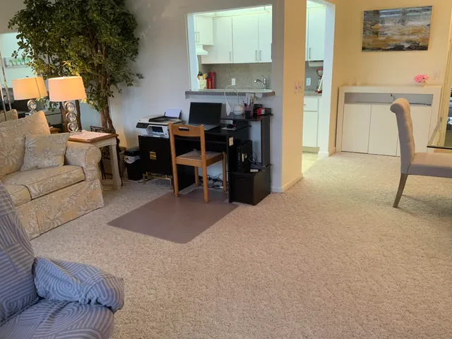 a living room with furniture a window and a piano
