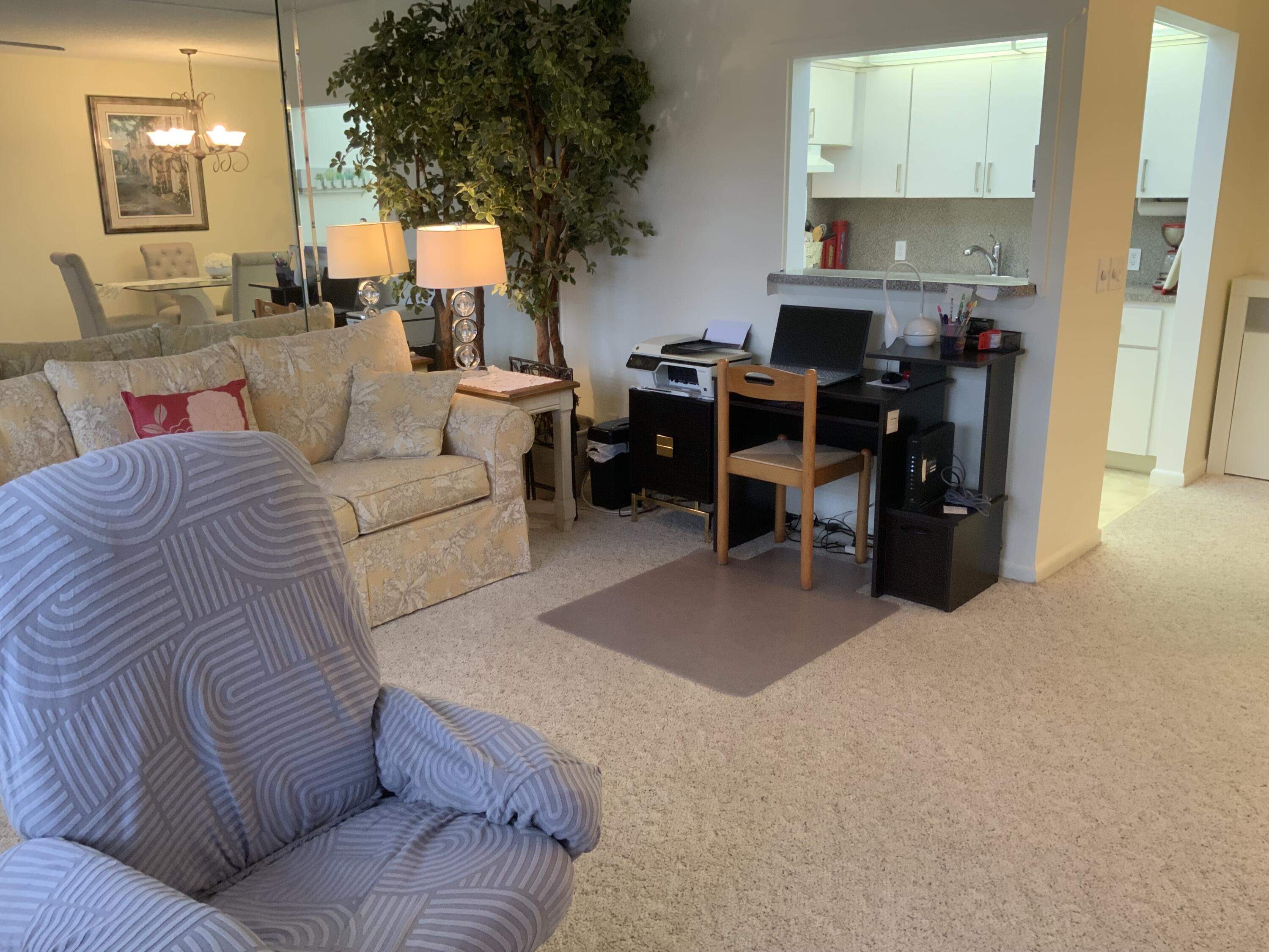 353 Dorset I Boca Raton, FL 33434 - Photo 5 of 30 a living room with furniture a fireplace and a potted plant