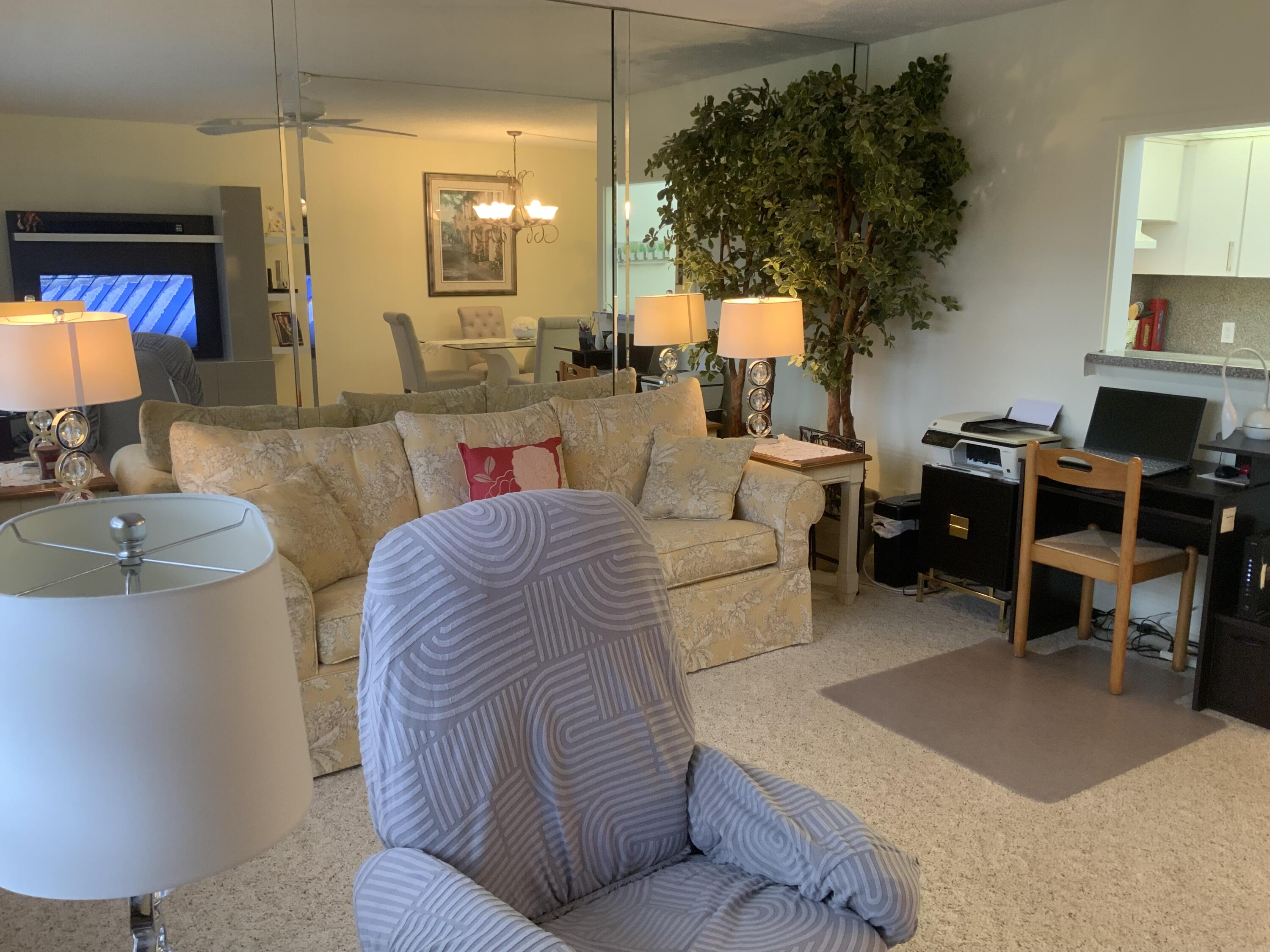 353 Dorset I Boca Raton, FL 33434 - Photo 6 of 30 a living room with furniture a lamp a rug and a potted plant