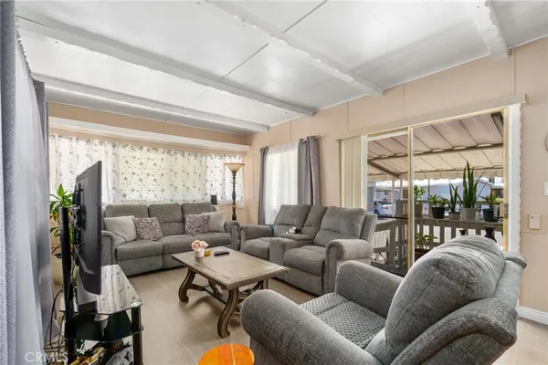 a living room with furniture and floor to ceiling windows