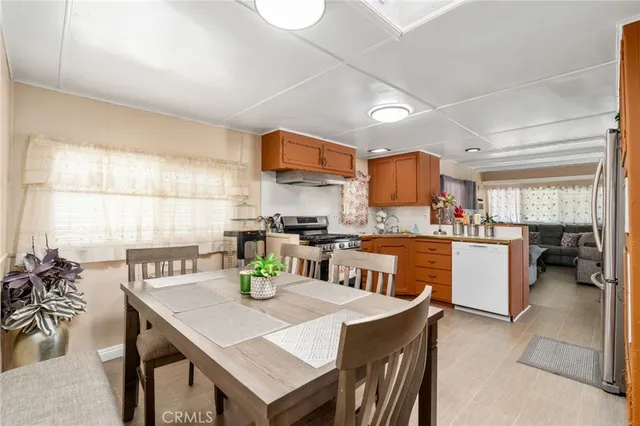 a kitchen with a table chairs and a refrigerator