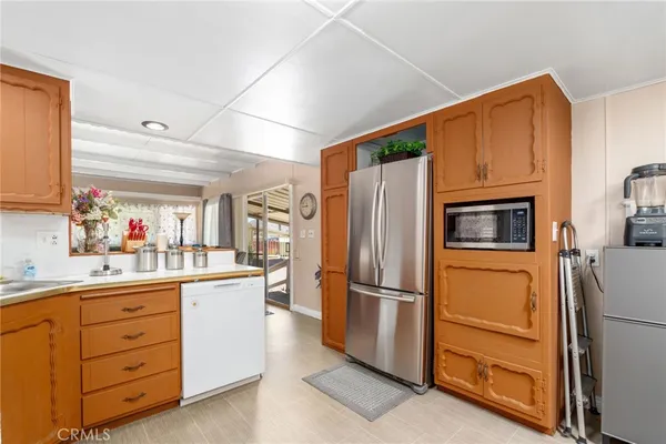 a kitchen with stainless steel appliances a refrigerator and cabinets