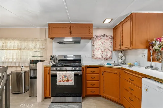 a kitchen with stainless steel appliances granite countertop a stove sink and cabinets
