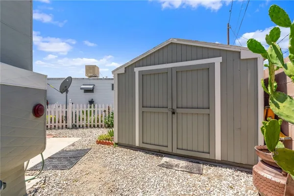 a view of a house with a small yard and wooden fence