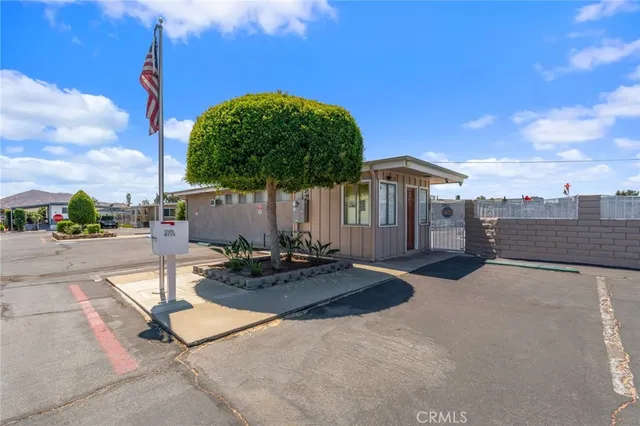 a view of a house with backyard and a patio