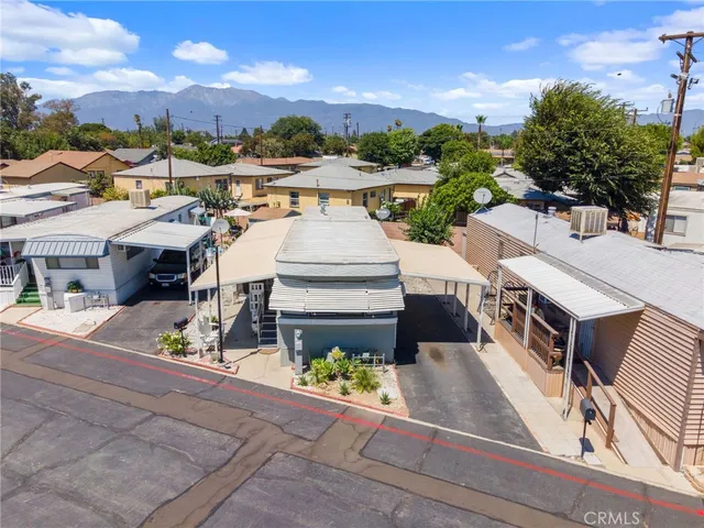 an aerial view of a house with garden space and street view