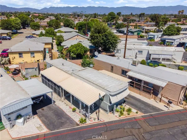 an aerial view of a house with swimming pool and mountain view