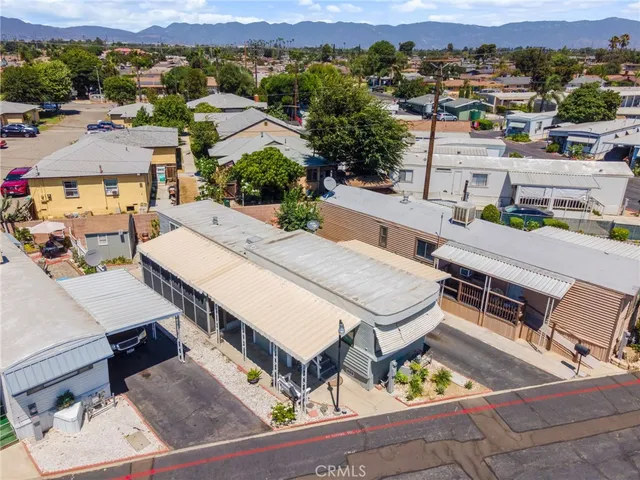 an aerial view of a house with swimming pool and mountain view