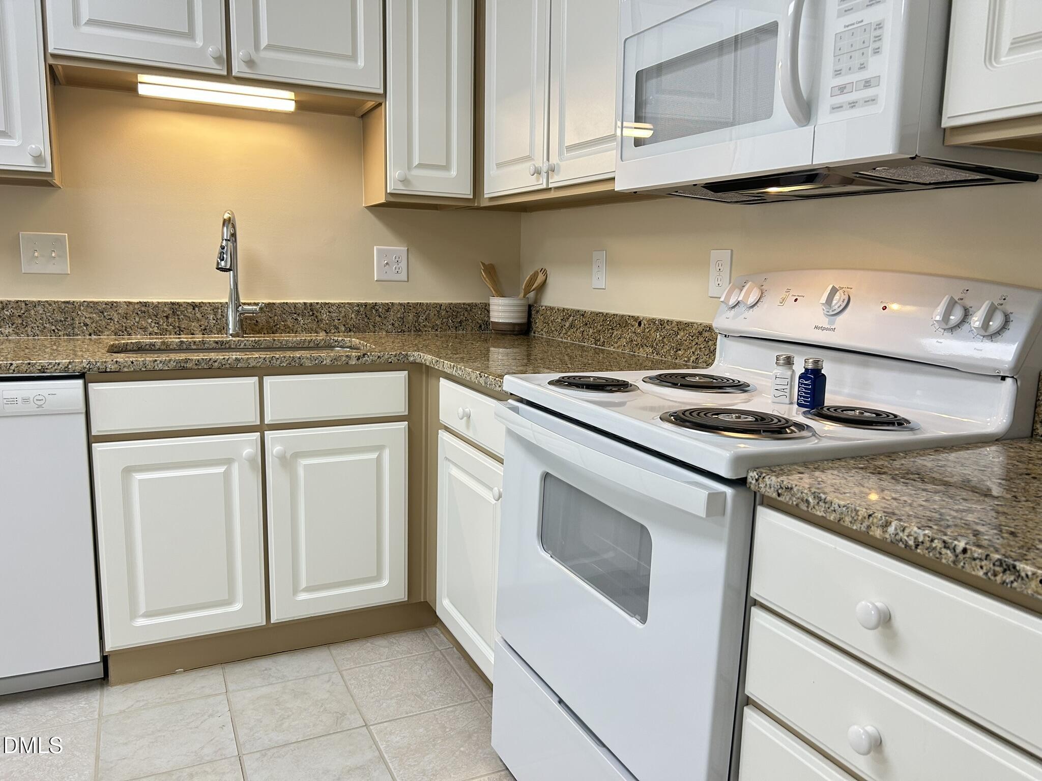 2510 Friedland Place, Unit 102 Raleigh, NC 27617 - Photo 10 of 42 a kitchen with granite countertop white cabinets and white appliances