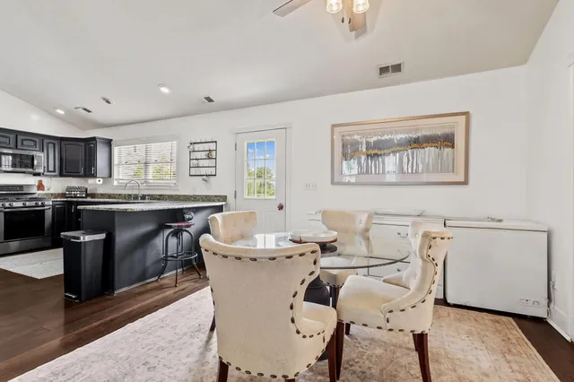 a view of a dining room with furniture and wooden floor