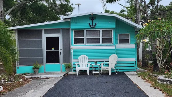a couple of chairs in front of house