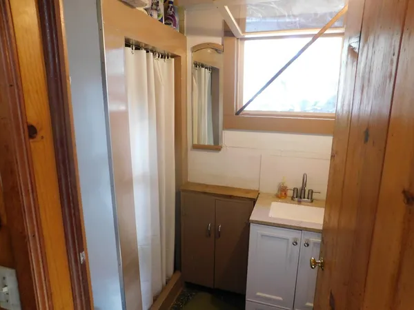 a bathroom with a sink a mirror and a window